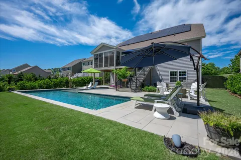 a view of a patio with a table and chairs under an umbrella