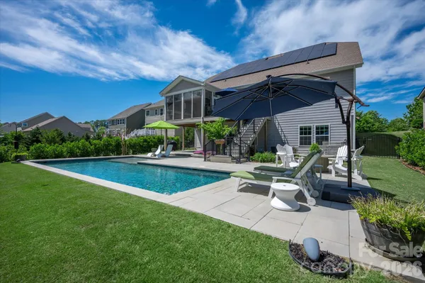 a view of a patio with a table and chairs under an umbrella