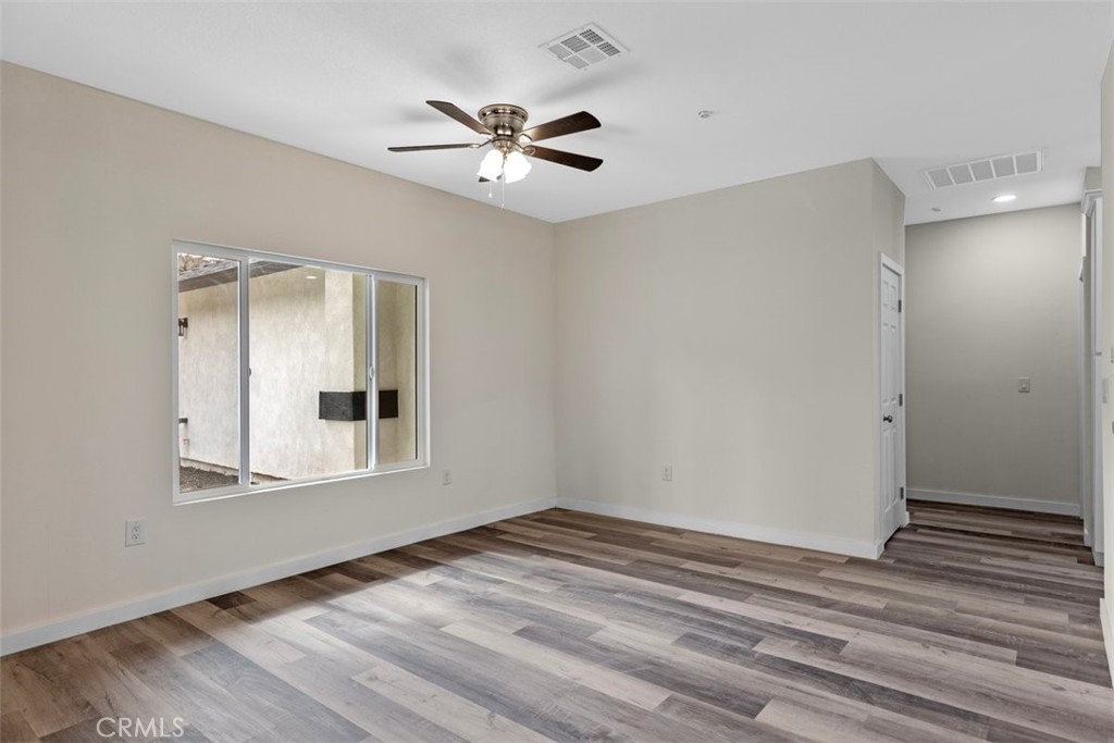 28551 Delaware Drive Tehachapi, CA 93561 - Photo 13 of 34 a view of an empty room with wooden floor and a window