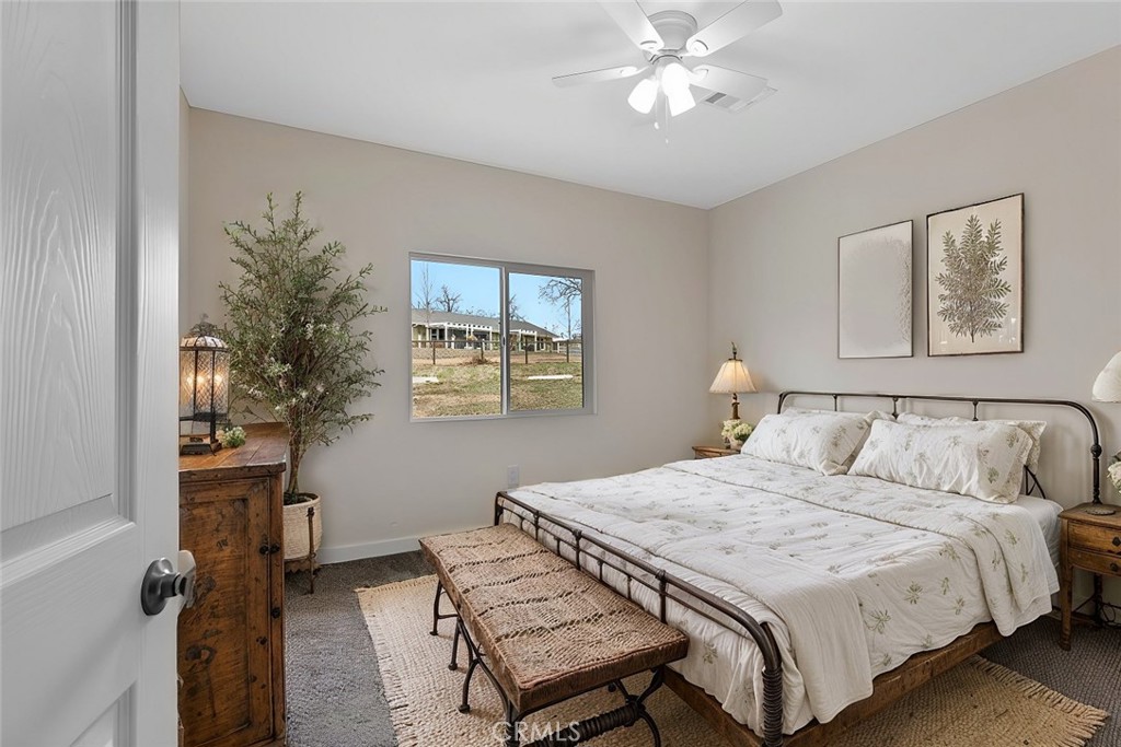 28551 Delaware Drive Tehachapi, CA 93561 - Photo 16 of 34 a bedroom with a bed and a chandelier