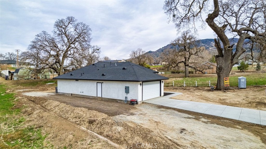 28551 Delaware Drive Tehachapi, CA 93561 - Photo 32 of 34 a front view of a house with a yard covered in snow