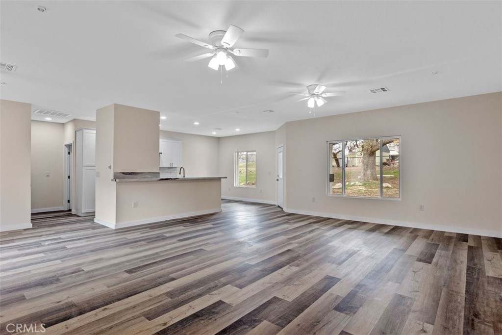 28551 Delaware Drive Tehachapi, CA 93561 - Photo 4 of 34 a view of an empty room with a window and wooden floor