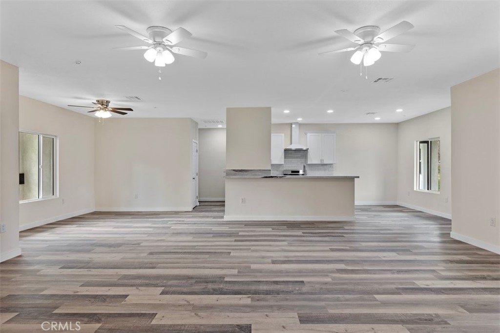 28551 Delaware Drive Tehachapi, CA 93561 - Photo 5 of 34 a view of kitchen with granite countertop cabinets and chandelier fan