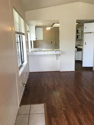 a view of kitchen with refrigerator and window