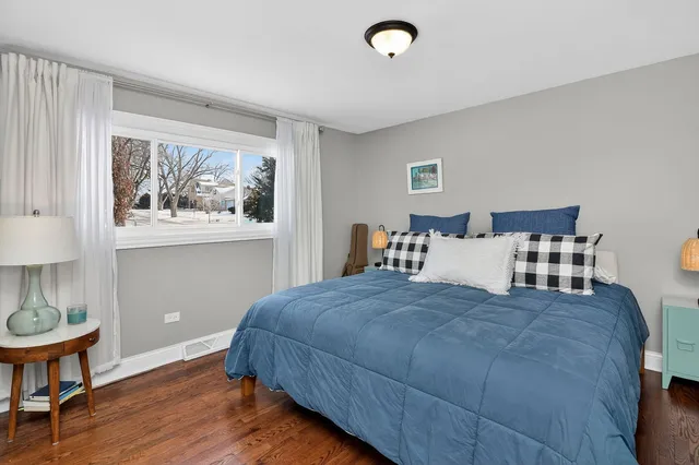 a bedroom with a bed and a table in it