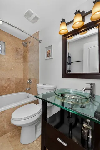 a bathroom with a sink a toilet and mirror