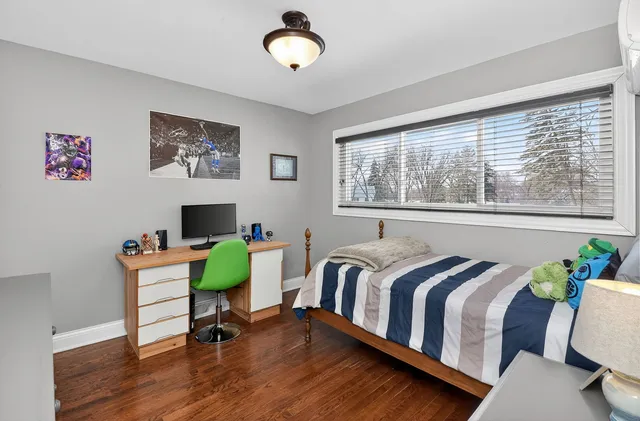 a bedroom with a bed and a chair