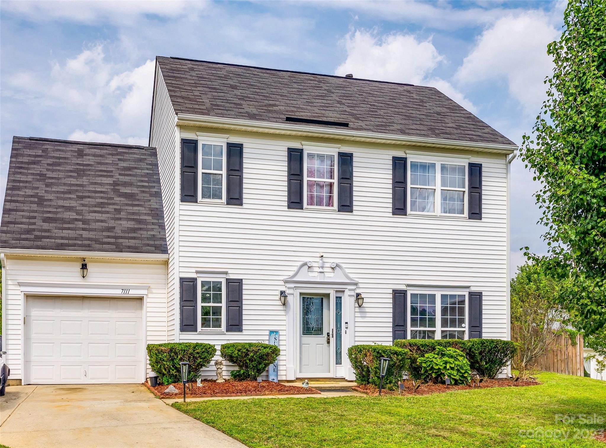 7111 Simbrah Way Charlotte, NC 28273 - Photo 1 of 23 a front view of a house with garden