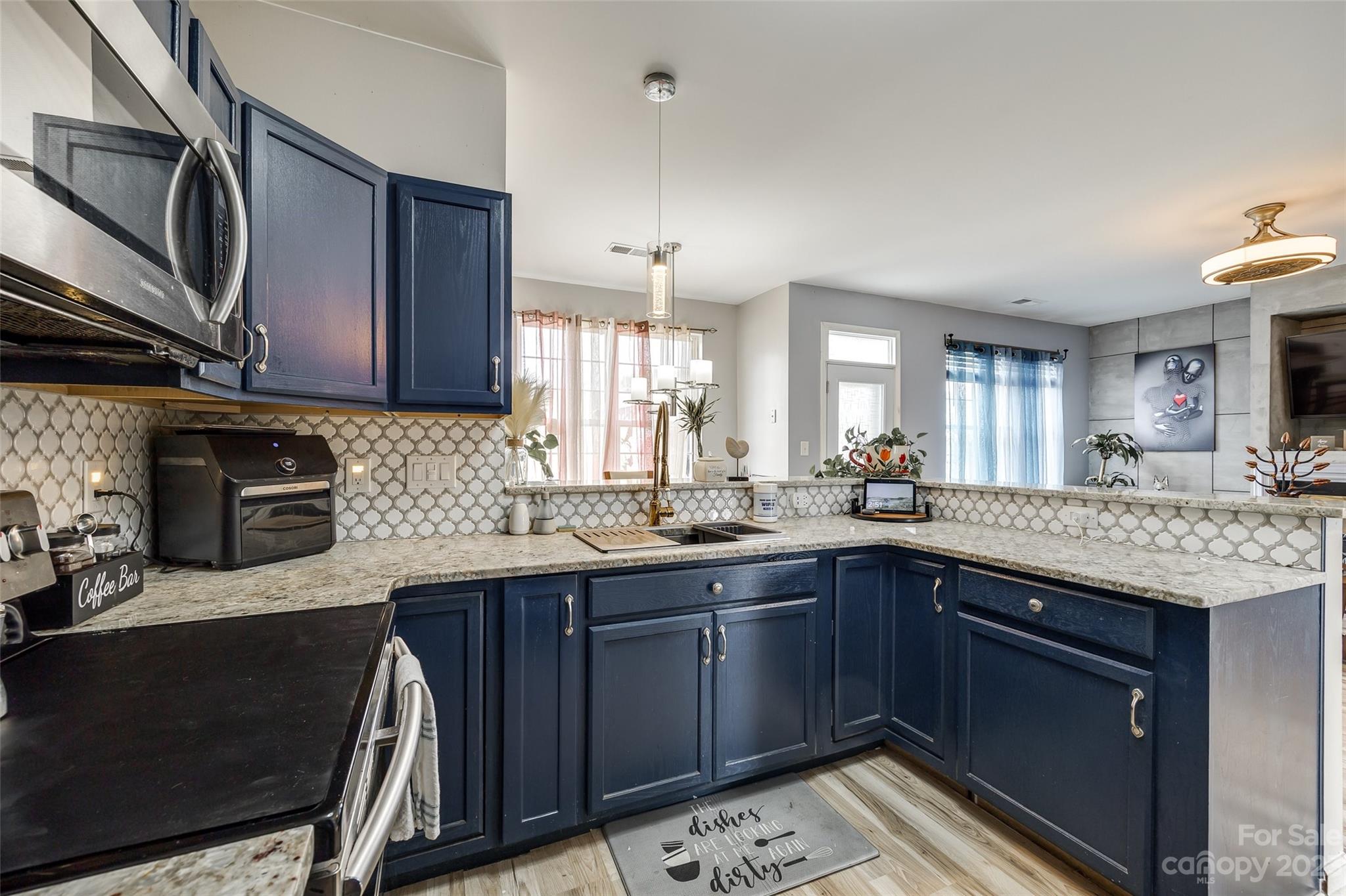 7111 Simbrah Way Charlotte, NC 28273 - Photo 12 of 23 a kitchen with a sink stove and cabinets