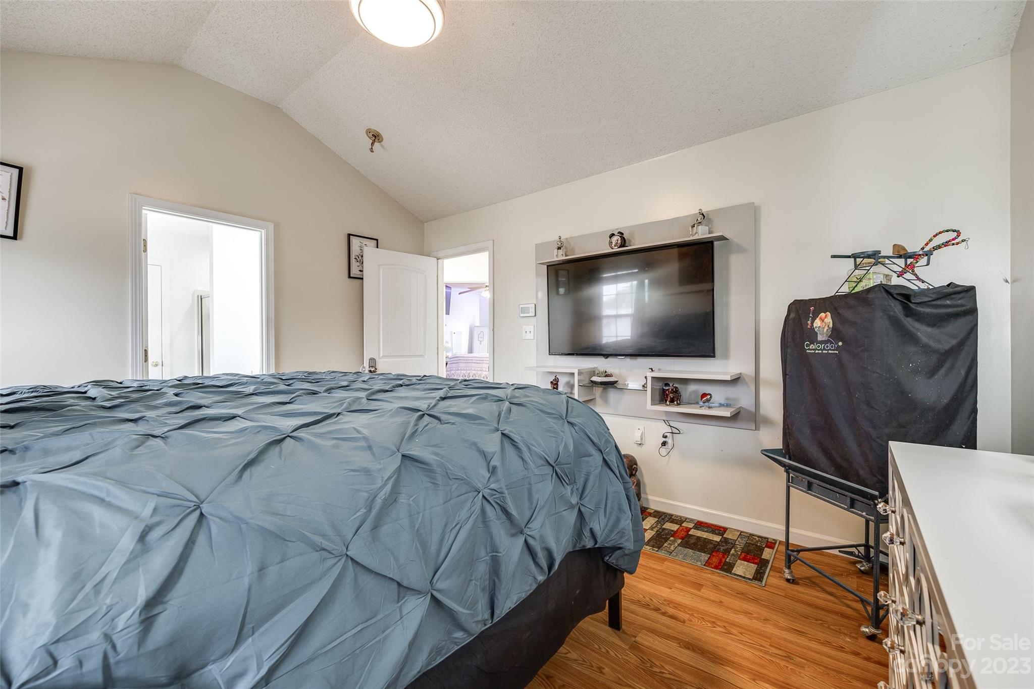 7111 Simbrah Way Charlotte, NC 28273 - Photo 14 of 23 a bedroom with a bed and a flat screen tv
