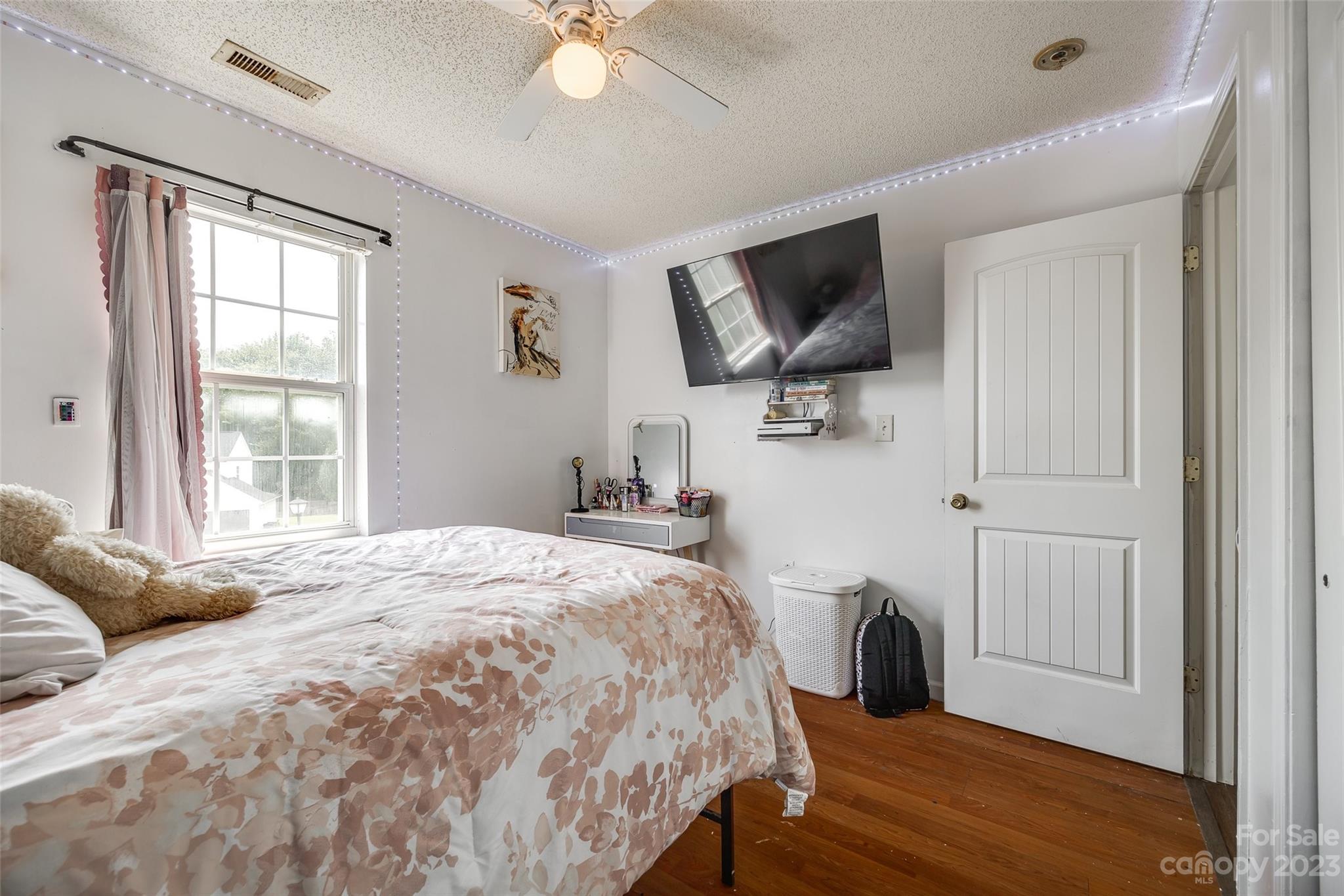 7111 Simbrah Way Charlotte, NC 28273 - Photo 17 of 23 a bedroom with a bed a flat screen tv and a window