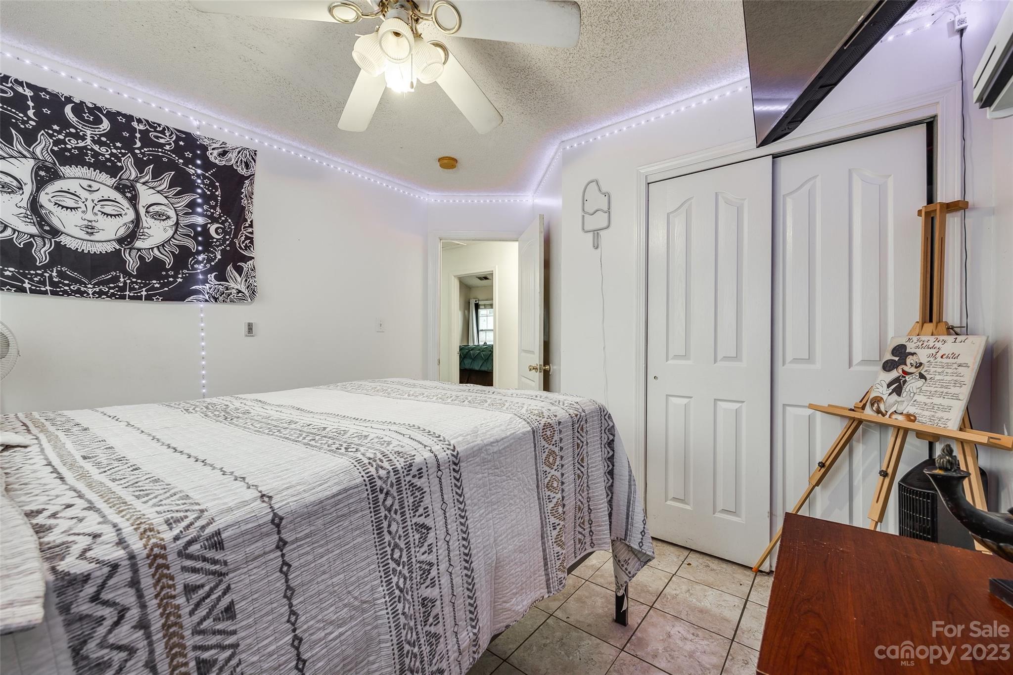 7111 Simbrah Way Charlotte, NC 28273 - Photo 18 of 23 a bedroom with a bed and a chandelier