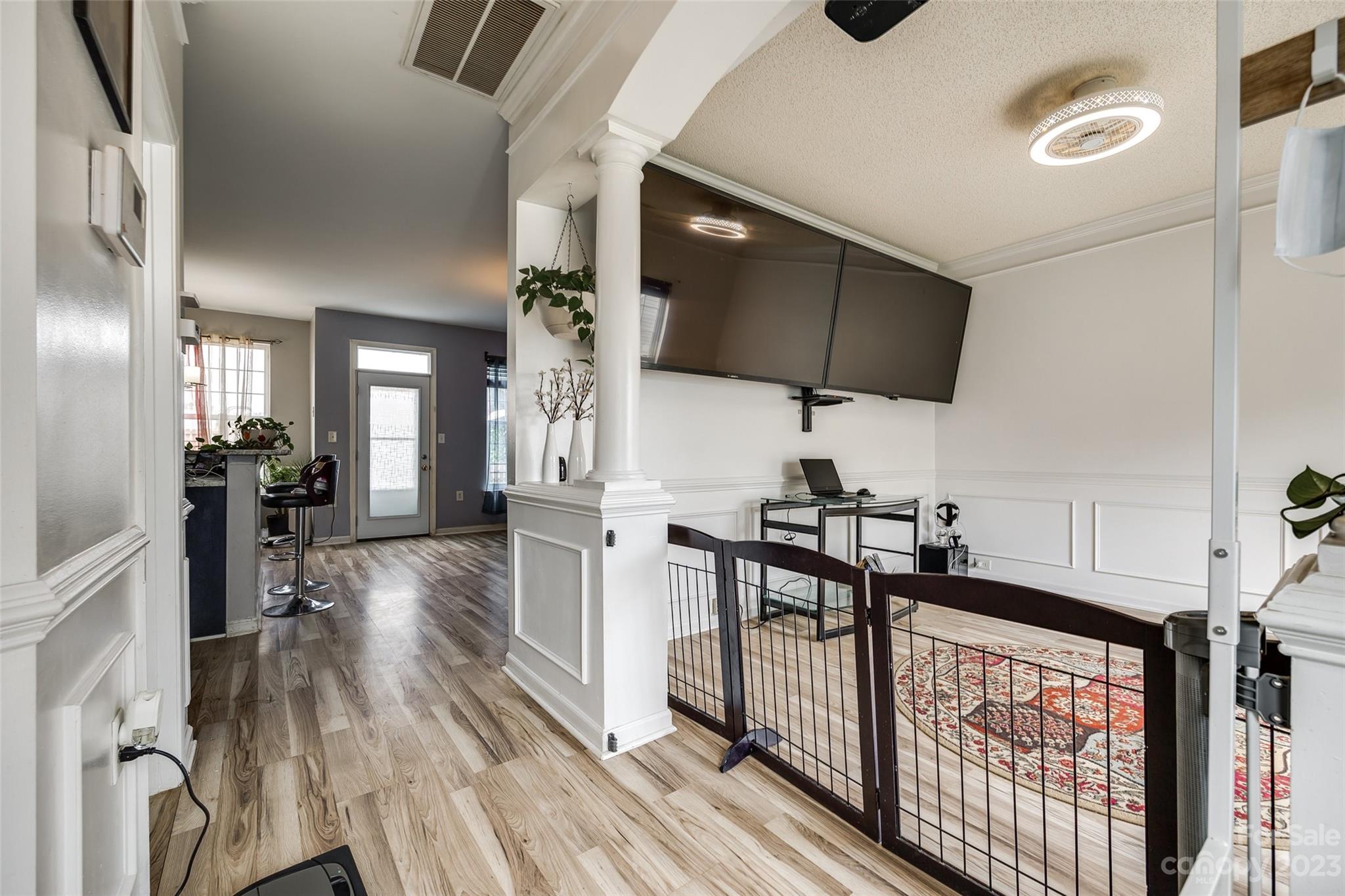 7111 Simbrah Way Charlotte, NC 28273 - Photo 3 of 23 a view of a hallway with wooden floor and furniture