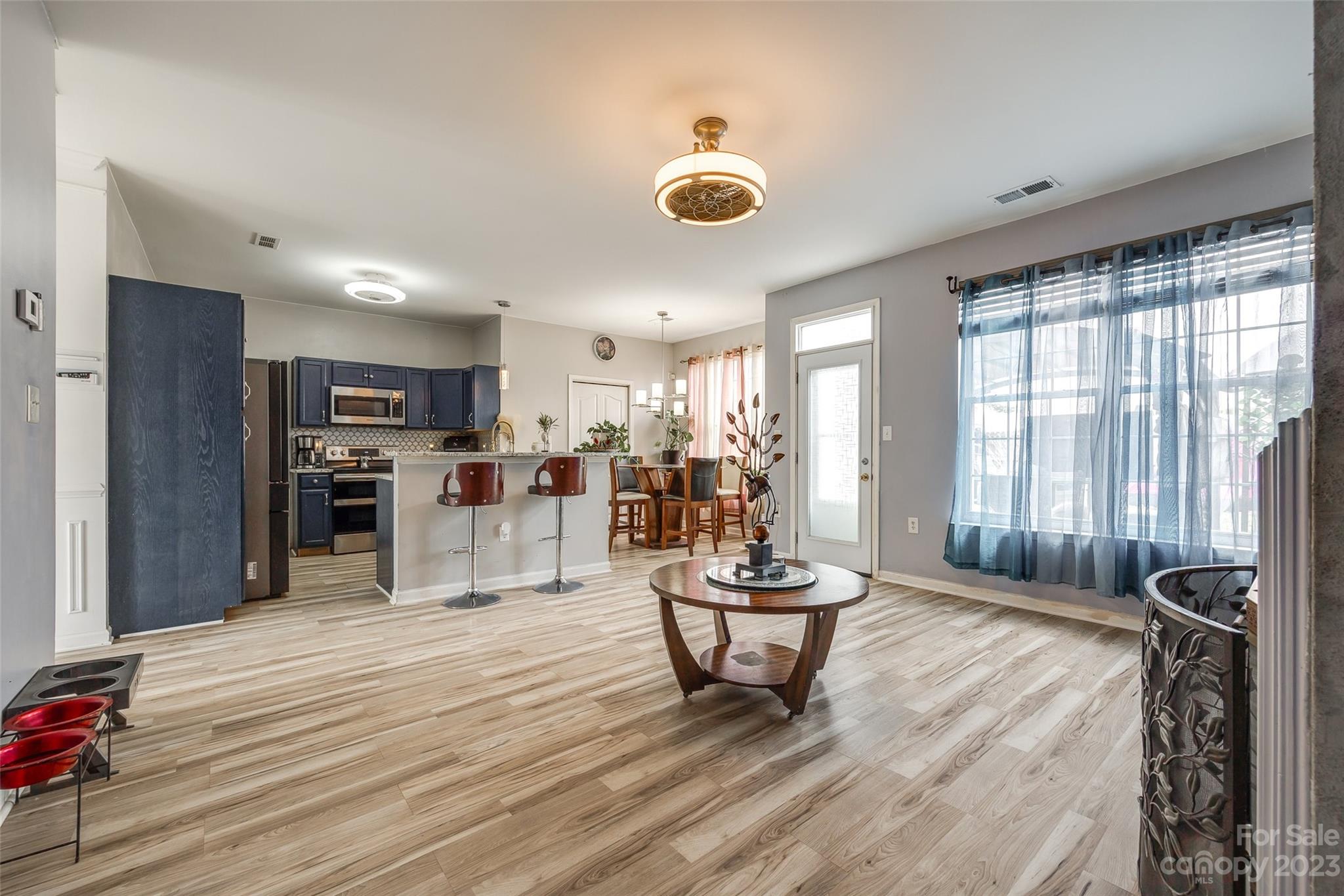 7111 Simbrah Way Charlotte, NC 28273 - Photo 8 of 23 a living room with furniture and a wooden floor
