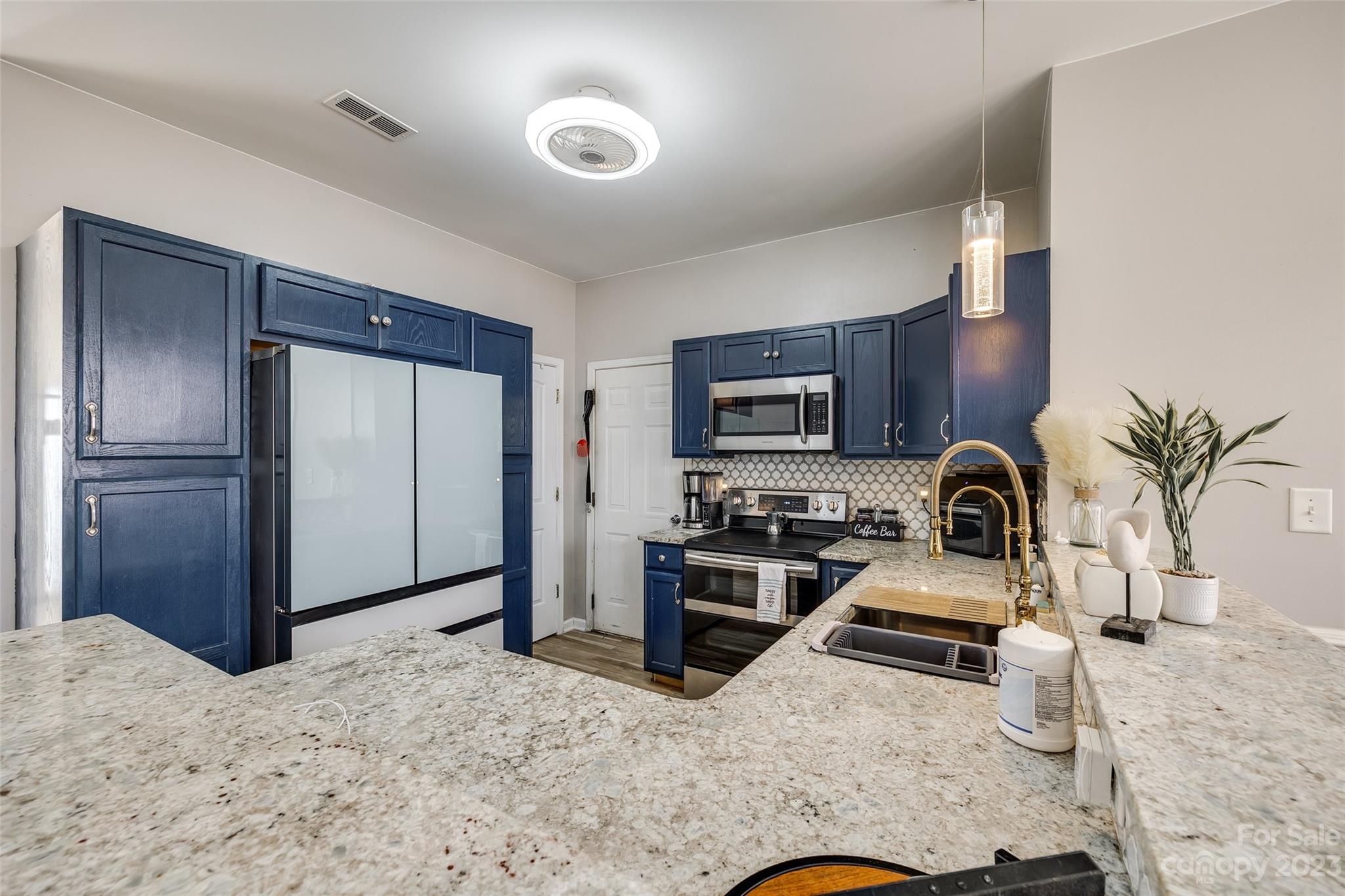 7111 Simbrah Way Charlotte, NC 28273 - Photo 10 of 23 a kitchen with stainless steel appliances granite countertop a refrigerator a stove and a sink
