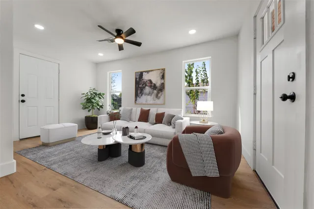 a living room with furniture potted plant and a window