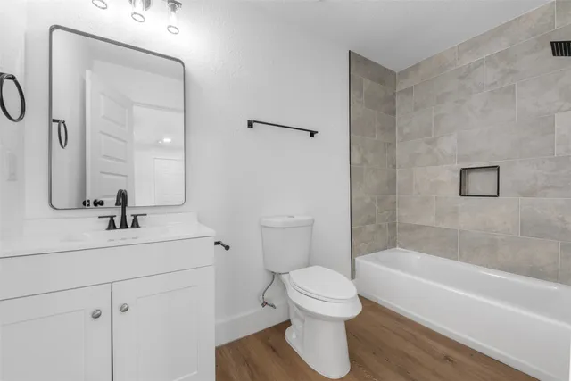 a bathroom with a sink toilet and shower