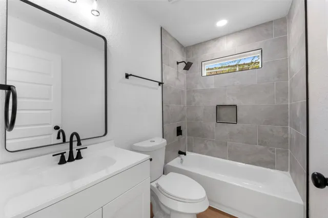 a bathroom with a sink a toilet and a bathtub