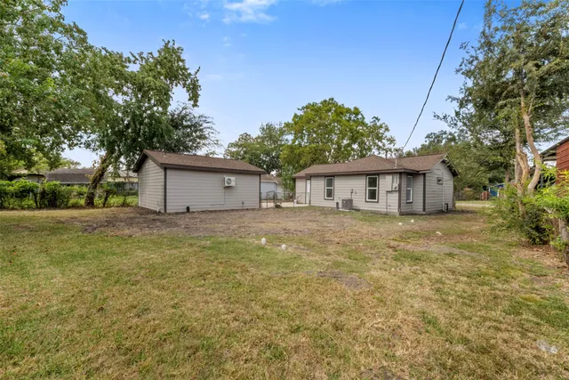 a front view of house with yard and trees