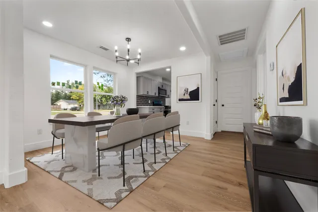 a very nice looking dining room with a large window