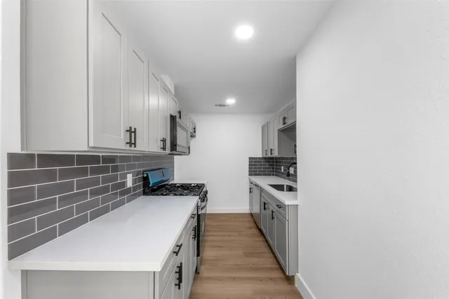 a kitchen with stainless steel appliances a sink and a stove