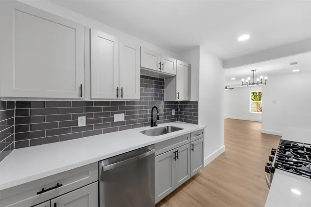 a kitchen with a sink and cabinets