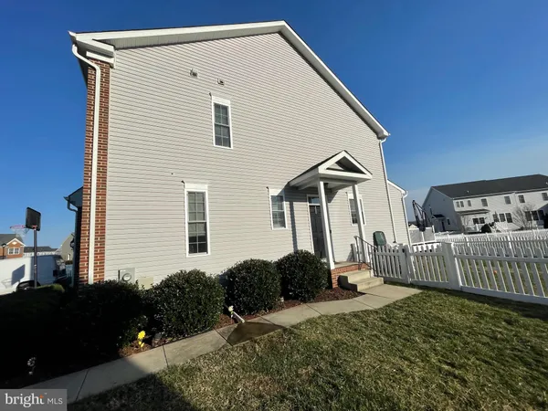 a view of backyard of house and car parked
