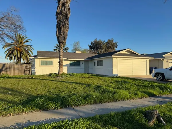 a front view of a house with a yard