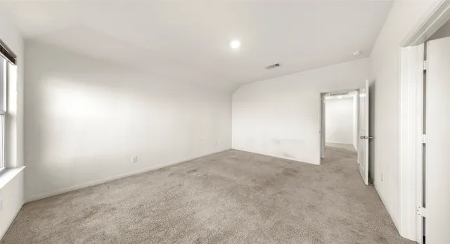 an empty room with windows and closet