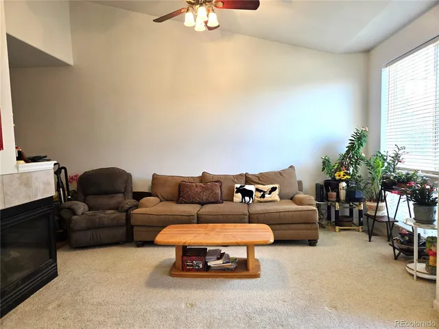 a living room with furniture a chandelier and a window