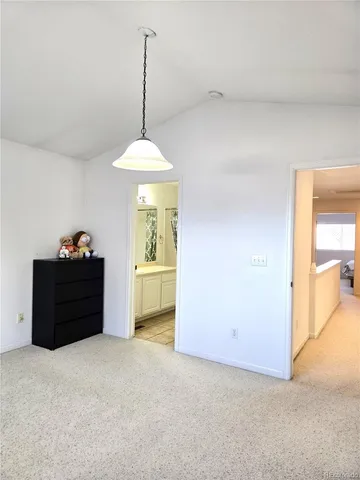 a bathroom with a granite countertop sink a toilet and shower