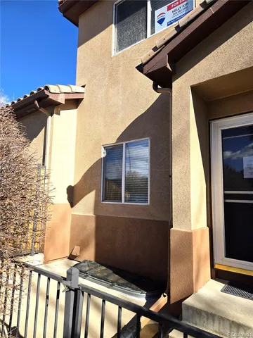 a view of a house with wooden fence