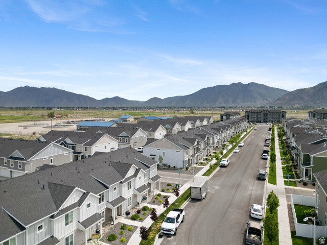 1223 East 1775 North Payson, UT 84651 - Photo 16 of 45 Aerial perspective showcasing a developed residential street lined with townhomes and detached properties, all featuring dark shingle roofs and light-colored siding