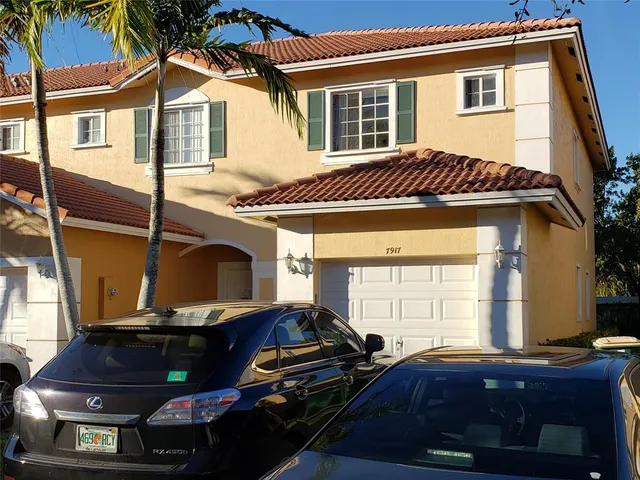 a view of house with a chairs and table in a patio
