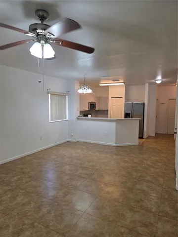 a view of a kitchen with a sink and a chandelier fan
