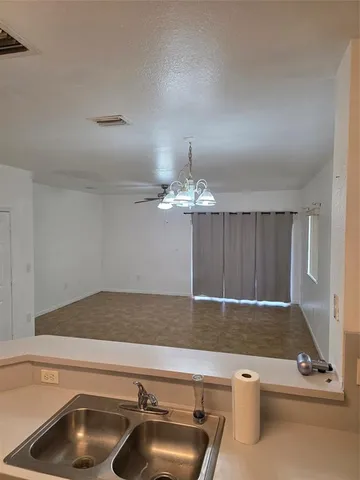 a room with a table chairs and wooden floor