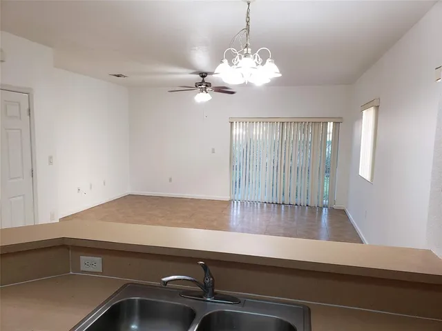 a view of a room with a sink and chandelier