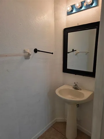 a bathroom with a sink toilet and mirror