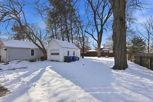 a view of a house with a yard covered in snow