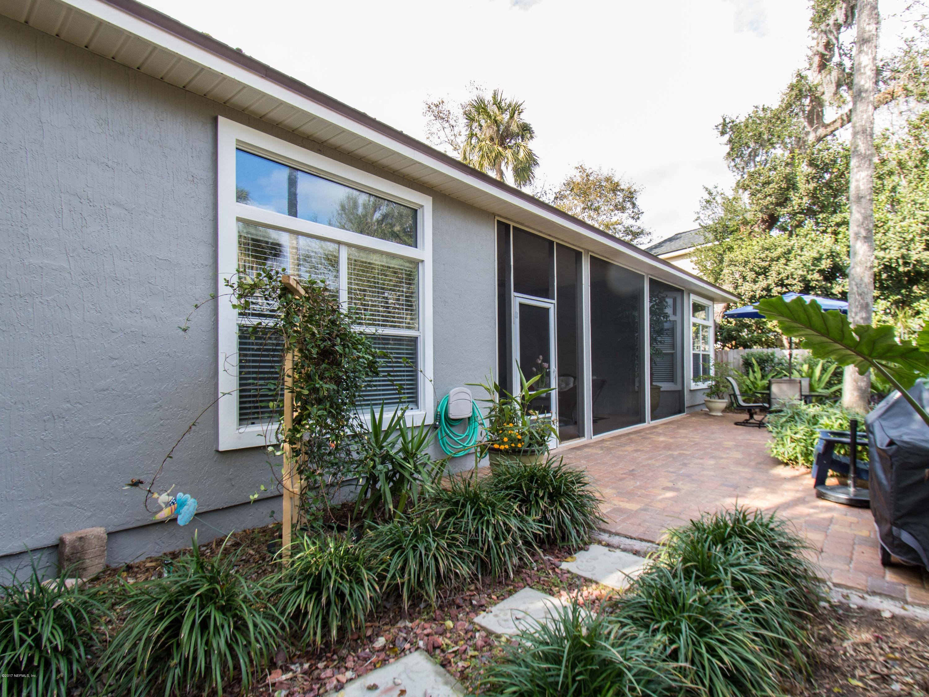 480 Big Tree Road Ponte Vedra Beach, FL 32082 - Photo 54 of 59 a view of a house with potted plants and a table and chairs