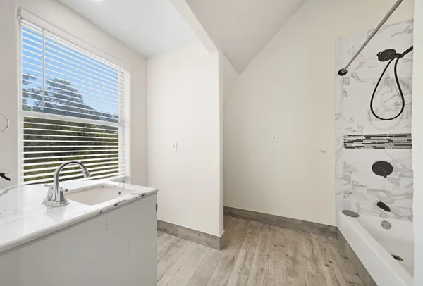 a bathroom with a tub and a shower