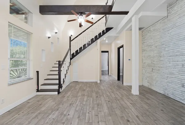 a view of entryway with wooden floor and stairs