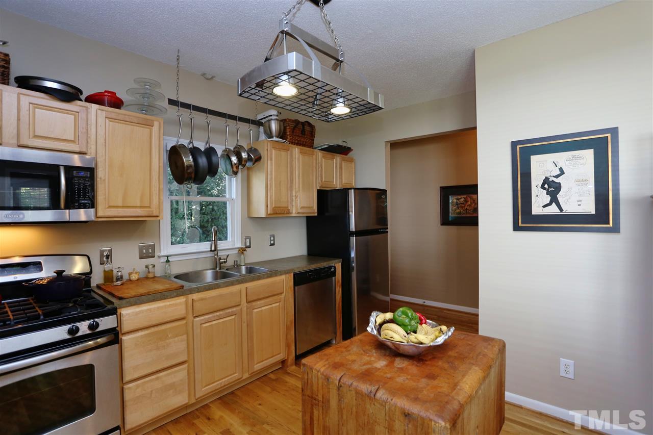 316 Cooke Street Raleigh, NC 27601 - Photo 7 of 23 a kitchen with stainless steel appliances granite countertop a sink a stove and refrigerator