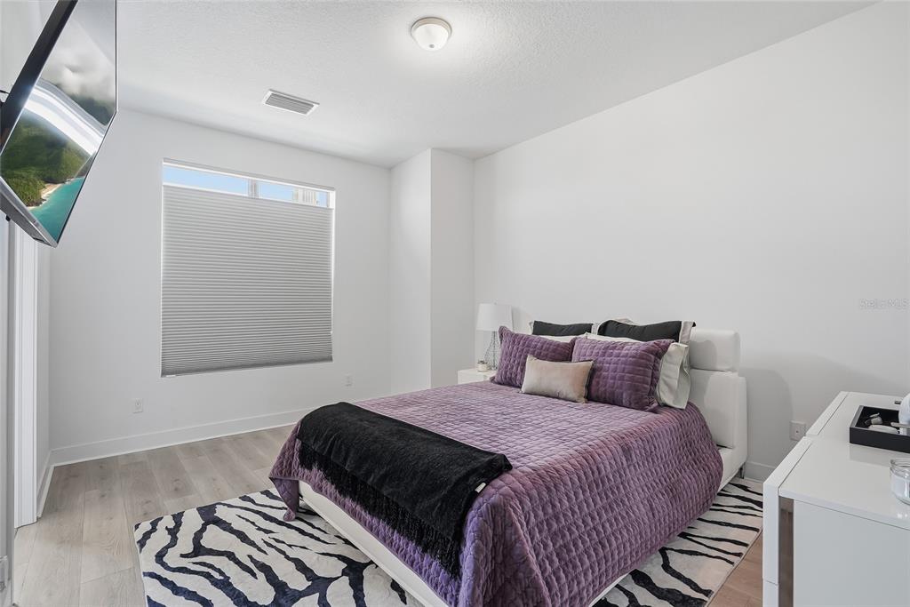 4810 West McElroy Avenue, Unit 30 Tampa, FL 33611 - Photo 24 of 43 a bedroom with a bed and a flat screen tv