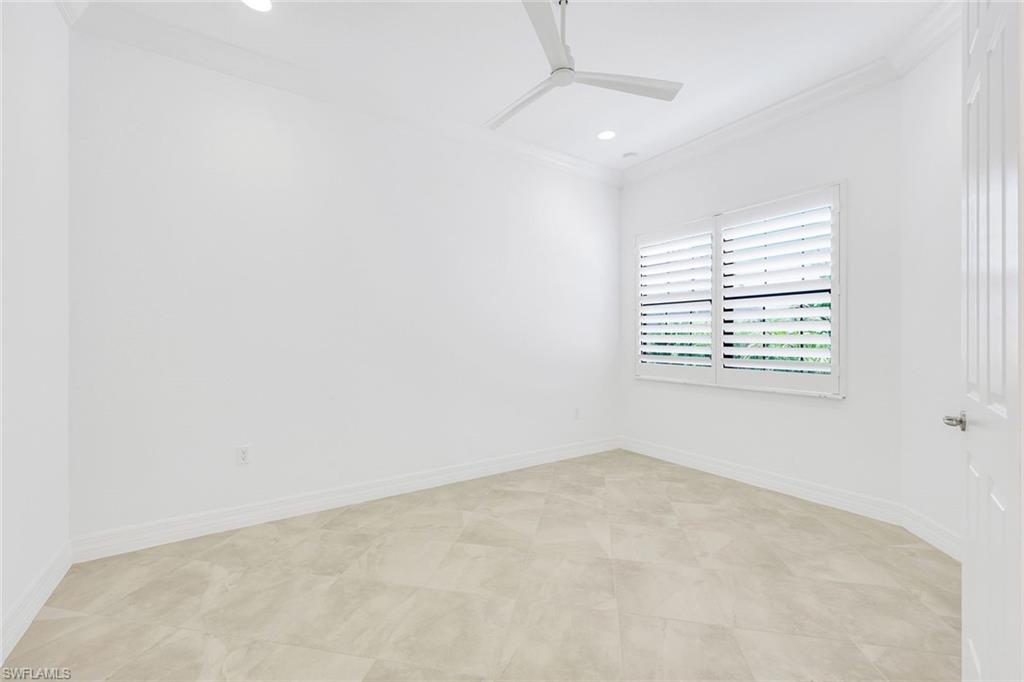 13670 Mandarin Circle Naples, FL 34109 - Photo 18 of 29 an empty room with windows