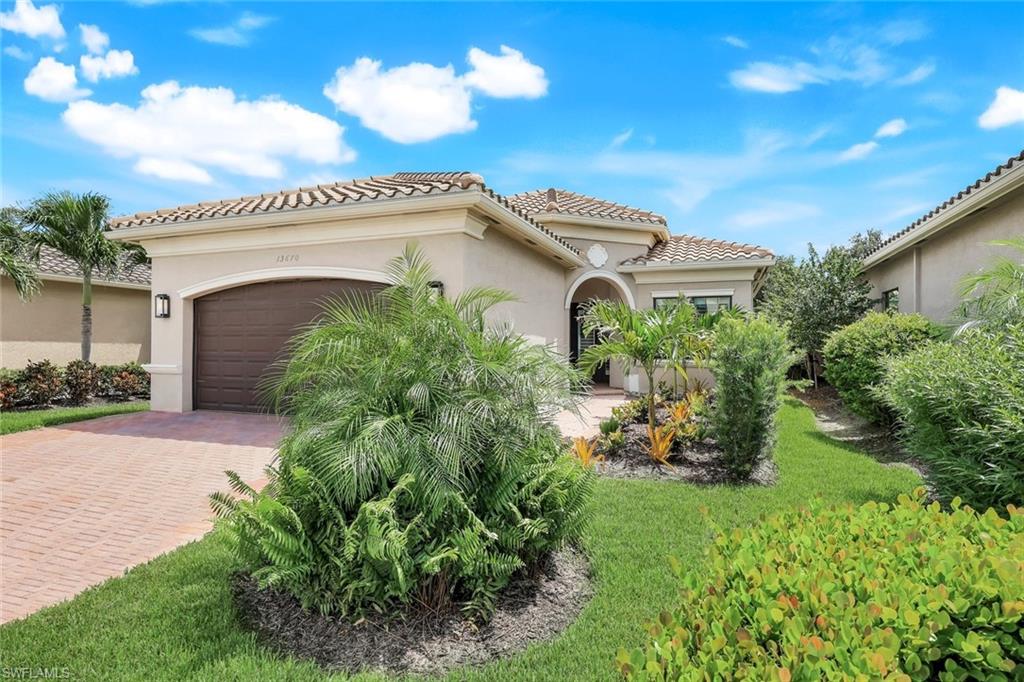 13670 Mandarin Circle Naples, FL 34109 - Photo 29 of 29 a front view of a house with a garden