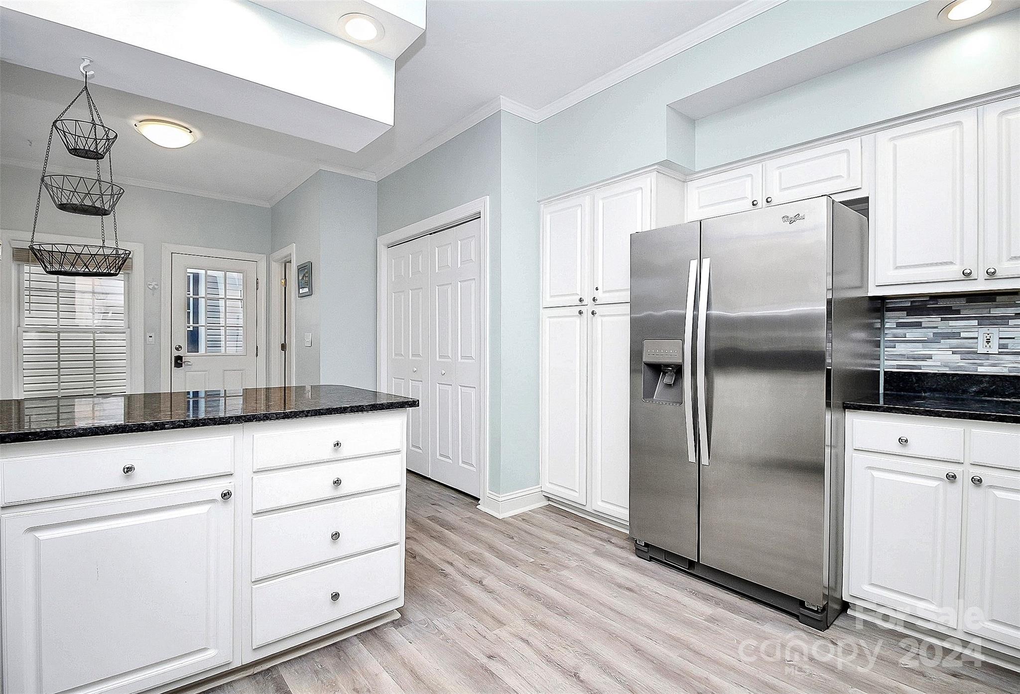 218 Stillwater Road Troutman, NC 28166 - Photo 11 of 43 a kitchen with white cabinets and refrigerator
