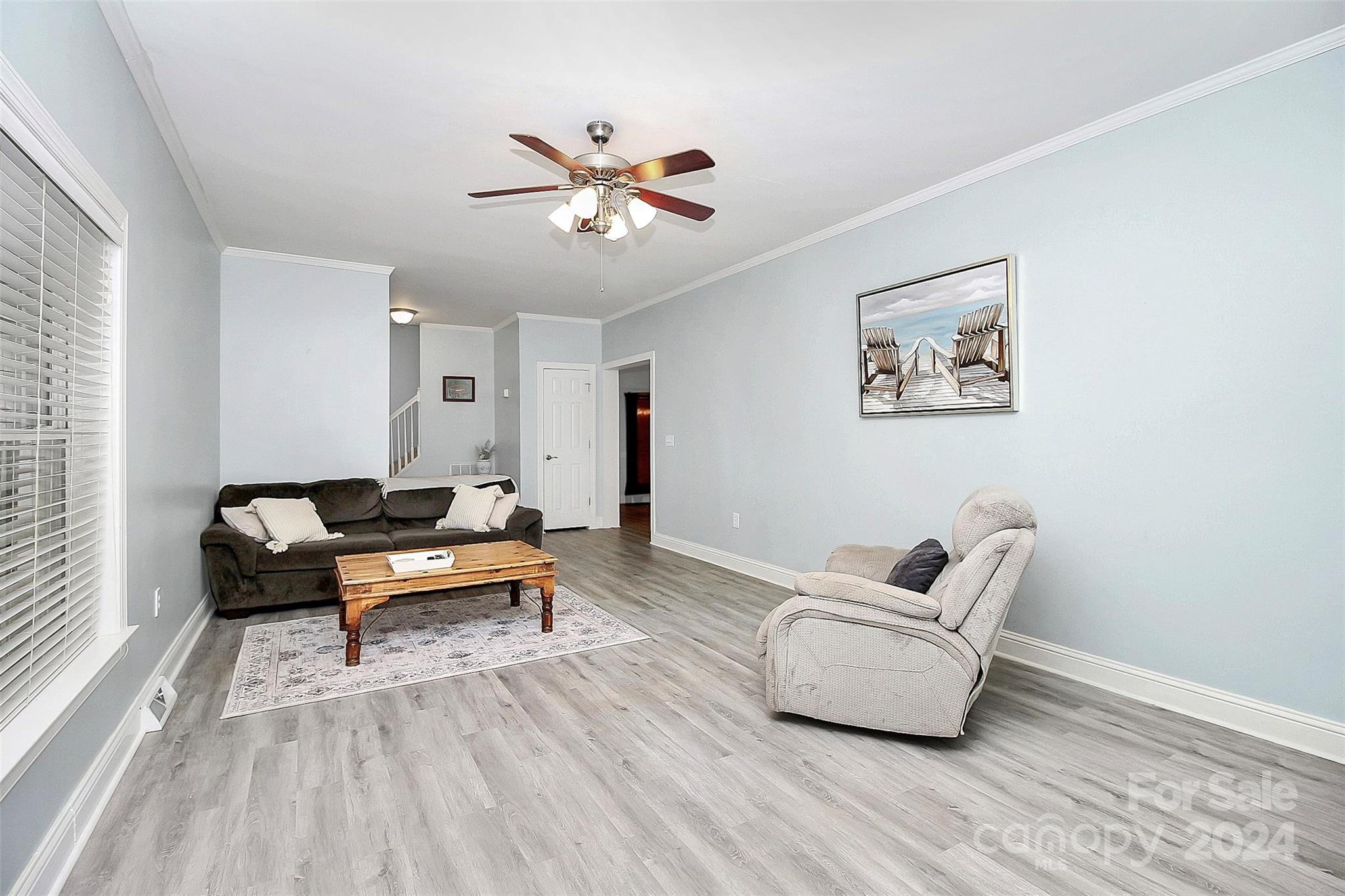 218 Stillwater Road Troutman, NC 28166 - Photo 16 of 43 a living room with furniture and a wooden floor