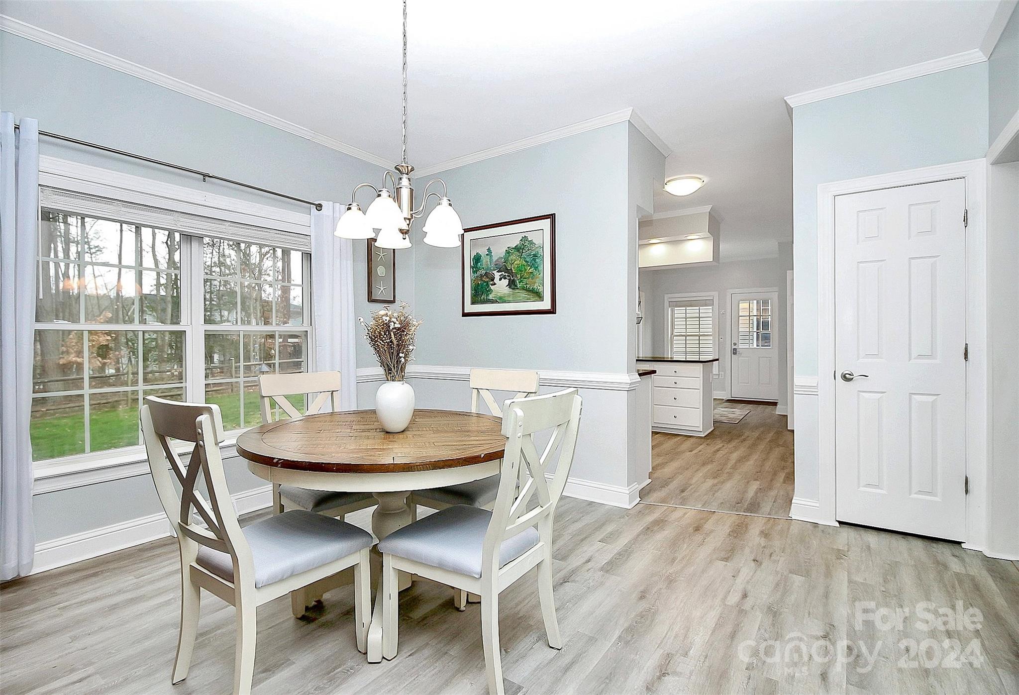 218 Stillwater Road Troutman, NC 28166 - Photo 20 of 43 a view of a dining room with furniture wooden floor and chandelier