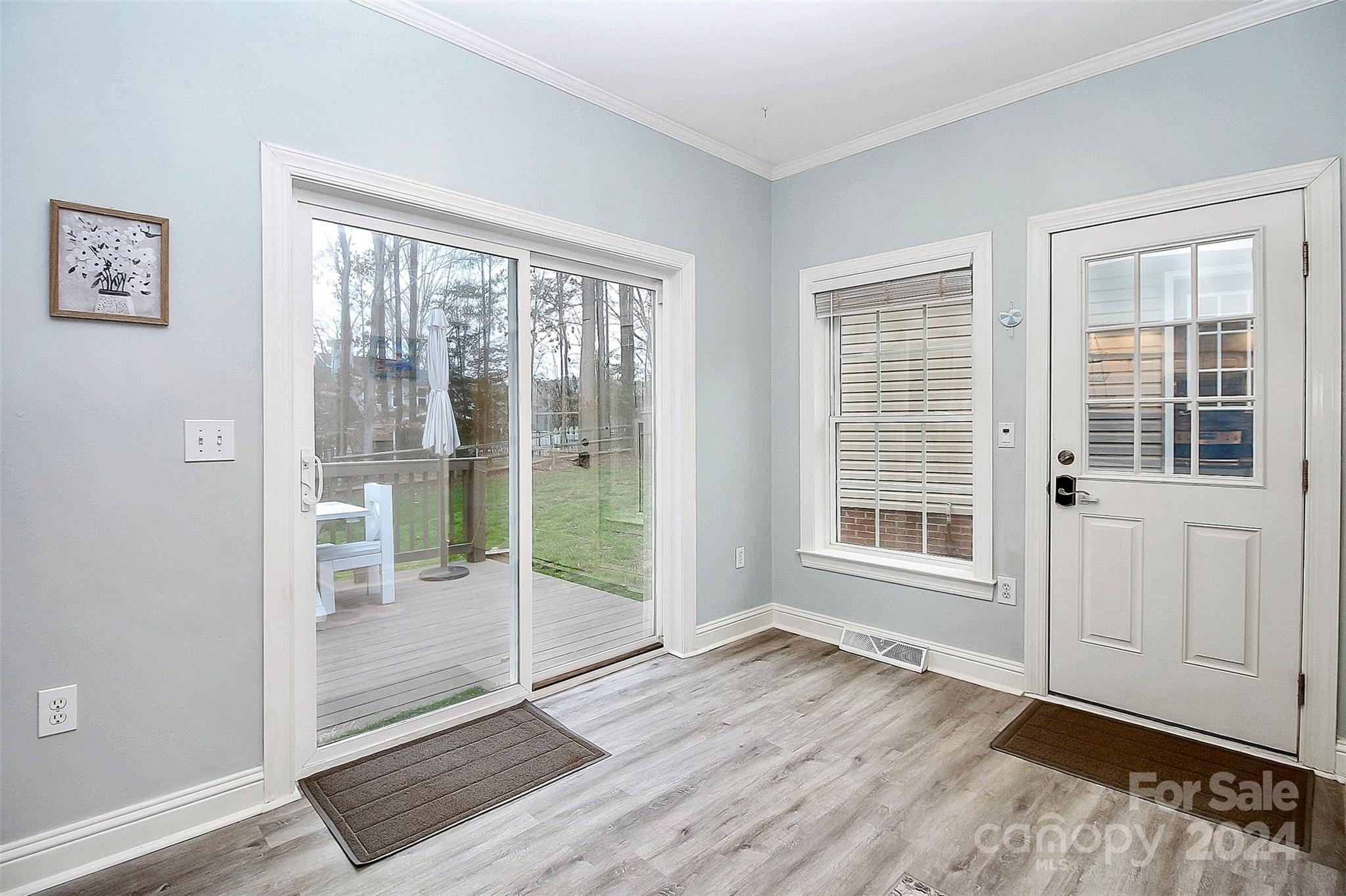 218 Stillwater Road Troutman, NC 28166 - Photo 21 of 43 an empty room with wooden floor and windows